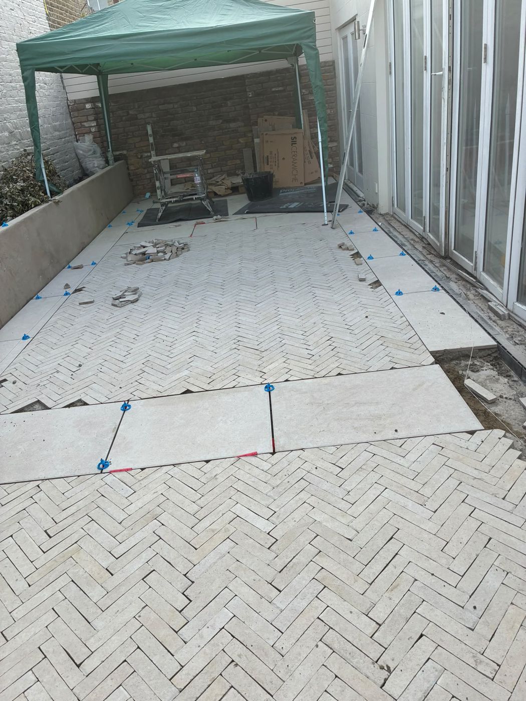 Herringbone and porcelain courtyard nearing completion