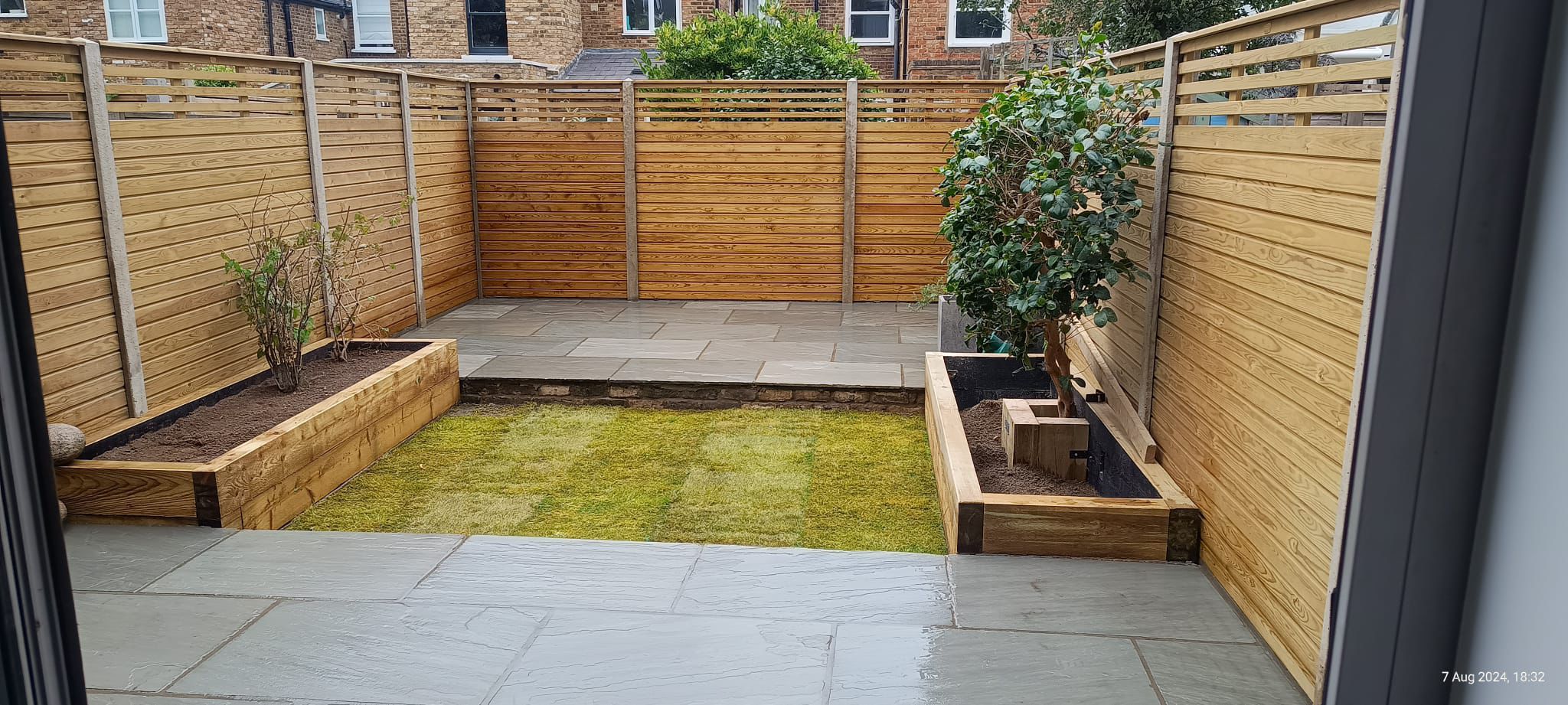 New lawn and slatted fencing